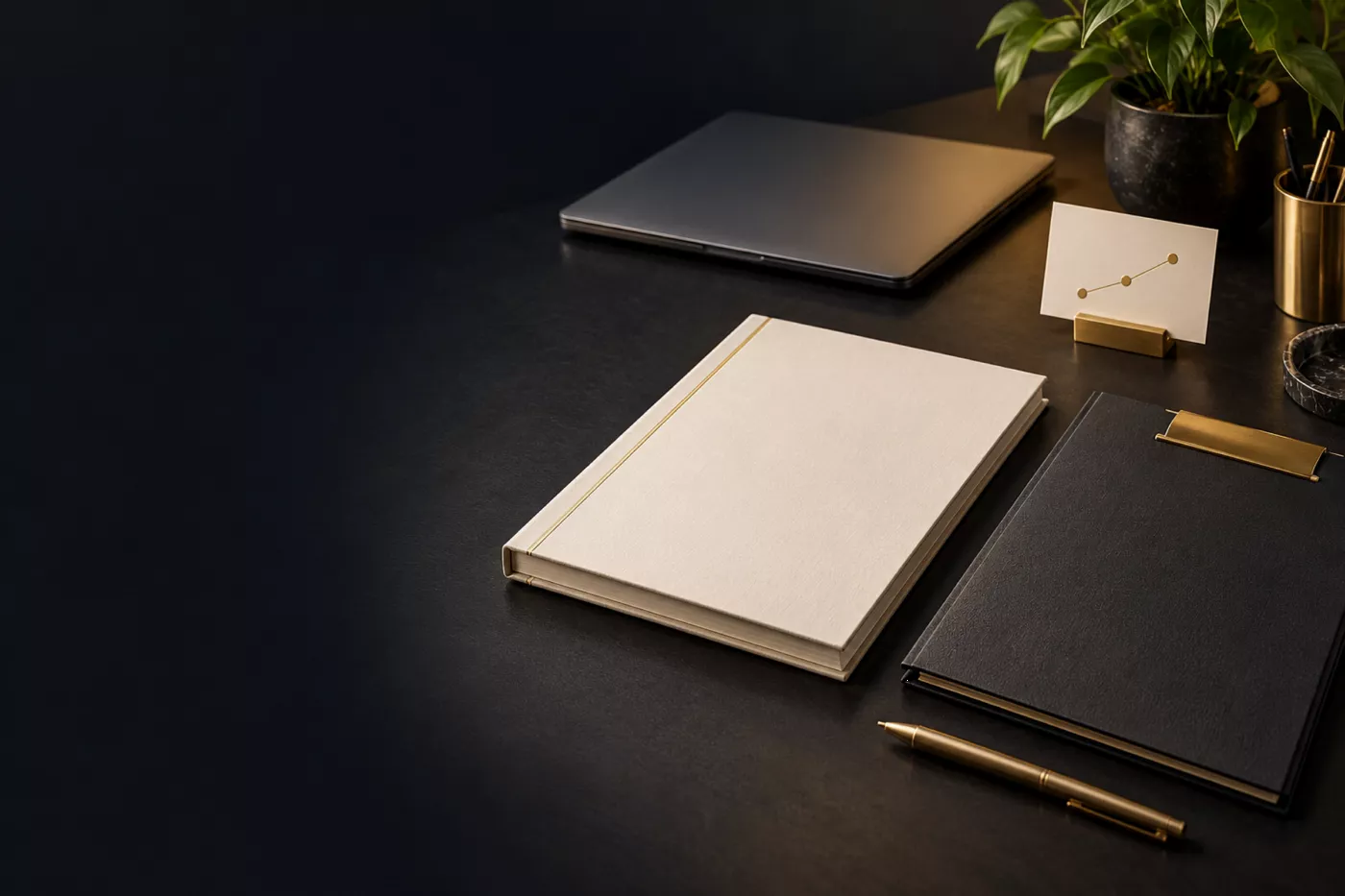 A founder’s desk with a pitch deck, a company file and a laptop